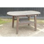 A varnished teak garden table with undertier, 137 x 70cm