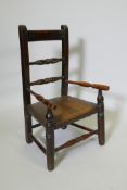A C19th child's elm spindle back open armchair, 68cm high