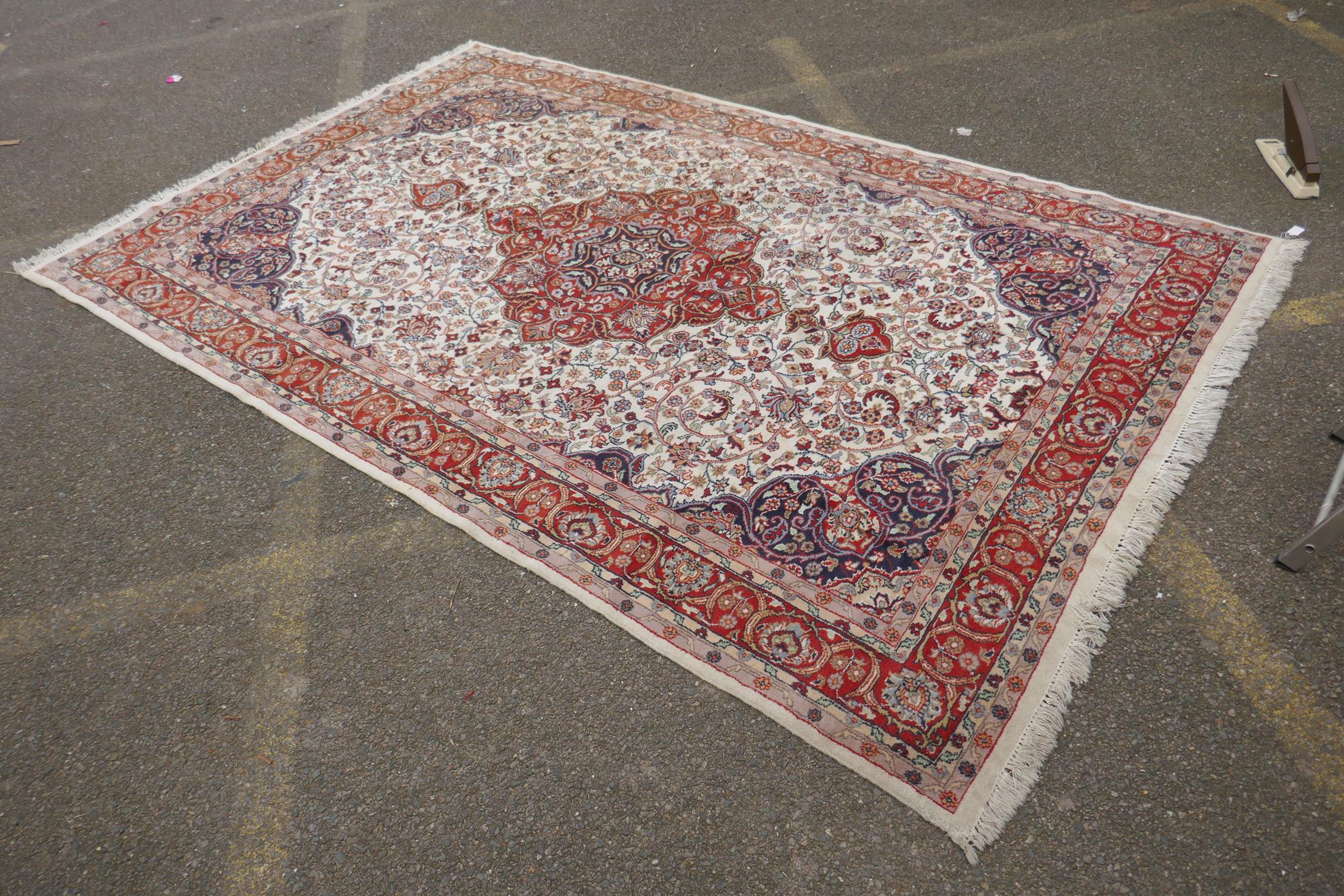 A Persian ivory ground wool Tabriz carpet with a floral medallion and red borders, 180 x 284cm - Image 3 of 6