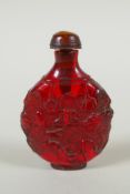 A Chinese amber style snuff bottle with lotus pond decoration, 7cm high