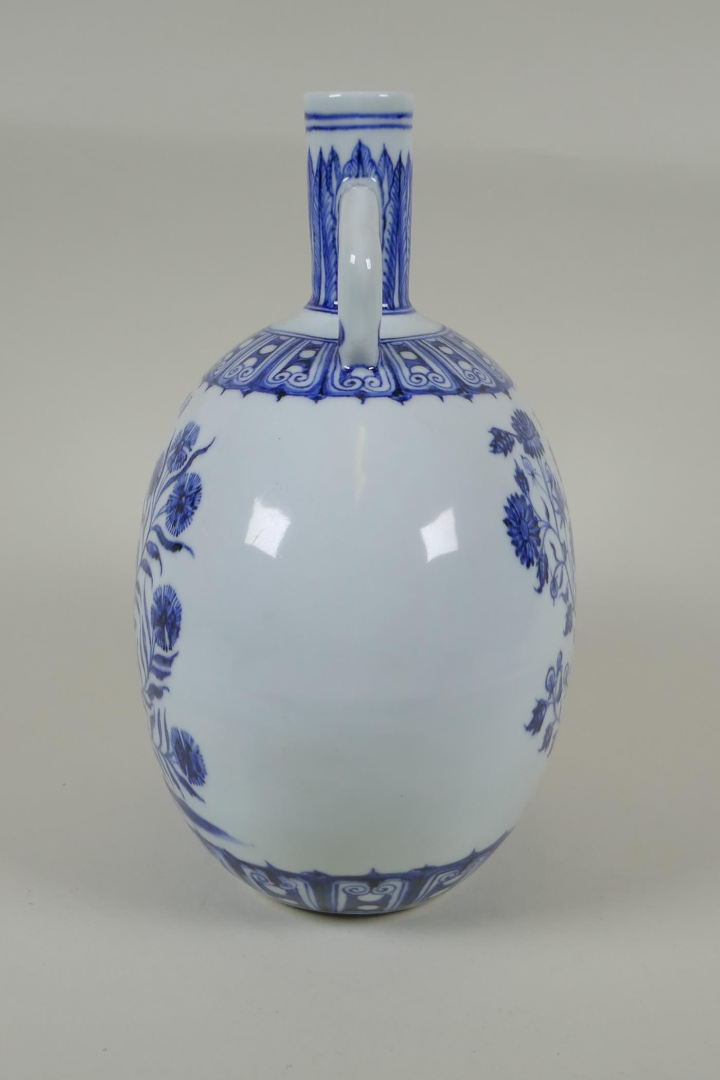 A Chinese blue and white porcelain moon flask with two handles and floral decoration, 4 character - Image 2 of 4