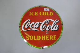 A Coca Cola vintage style enamelled metal sign, 30cm diameter
