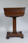 A Victorian oak workbox, the lift up top with fitted interior, raised on a tapering column and