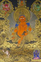 A Tibetan painted thangka depicting Jambhala, housed within a silk mount, 80 x 124cm