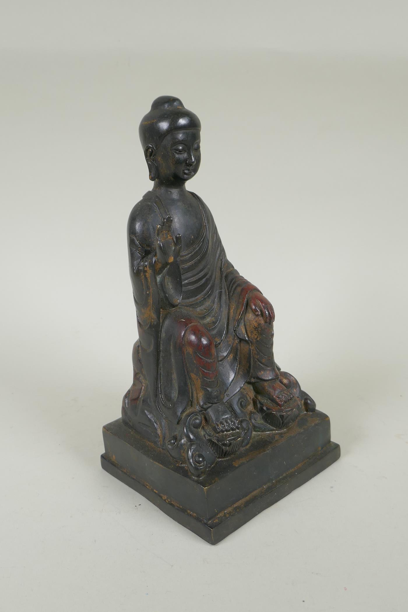 A Chinese bronze Buddha seated on a throne, with the remnants of gilt and copper patina, 23cm high - Image 4 of 5