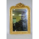 A C19th French giltwood and composition wall mirror with carved crest and original glass, 79 x 116cm