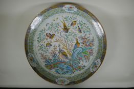 An C18th/C19th Chinese famille verte porcelain charger decorated with peacocks and asiatic birds