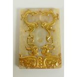 A Chinese carved and gilt jade tablet with archaic phoenix and dragon decoration, 8 x 12cm