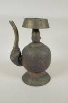 A Tibetan embossed bronzed metal pourer with raised kylin decoration, 26cm high