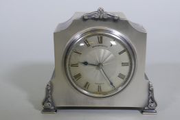 An Edwardian brushed silver plate mantel clock, the dial with engine turned decoration and enamel