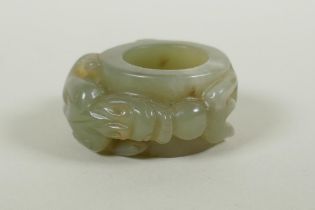 A Chinese carved celadon archers thumb ring, with kylin decoration, 5cm diameter