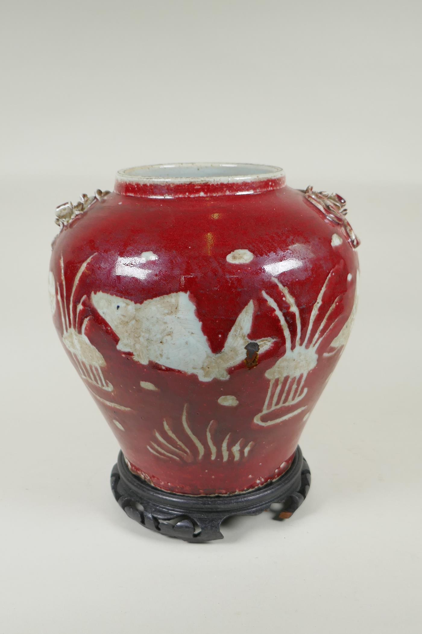 A Chinese red and white porcelain baluster vase, decorated with carp in a lotus pond, on a carved - Image 3 of 5