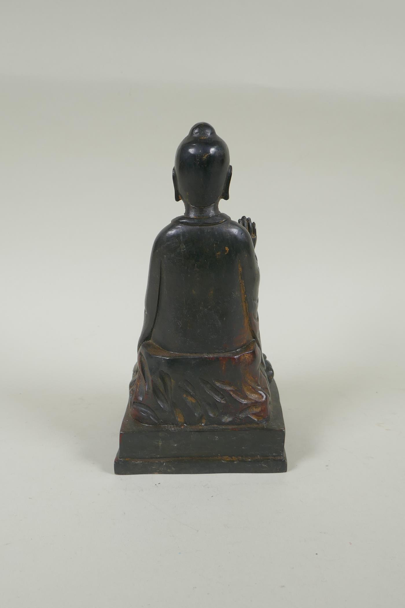 A Chinese bronze Buddha seated on a throne, with the remnants of gilt and copper patina, 23cm high - Image 3 of 5