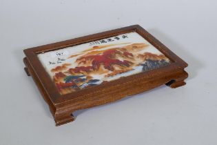 A Chinese hardwood stand with inset porcelain panel, 29 x 20 x 5cm