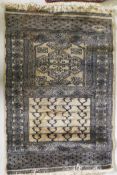 A hand woven wool Middle Eastern prayer rug, signed, 60 x 90cm, and another smaller
