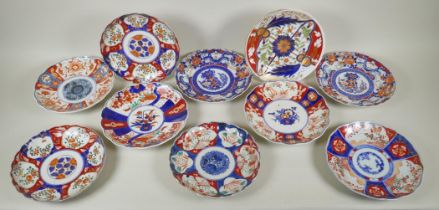 Ten C19th Japanese Imari porcelain plates with scalloped rims and floral decoration, largest 22cm