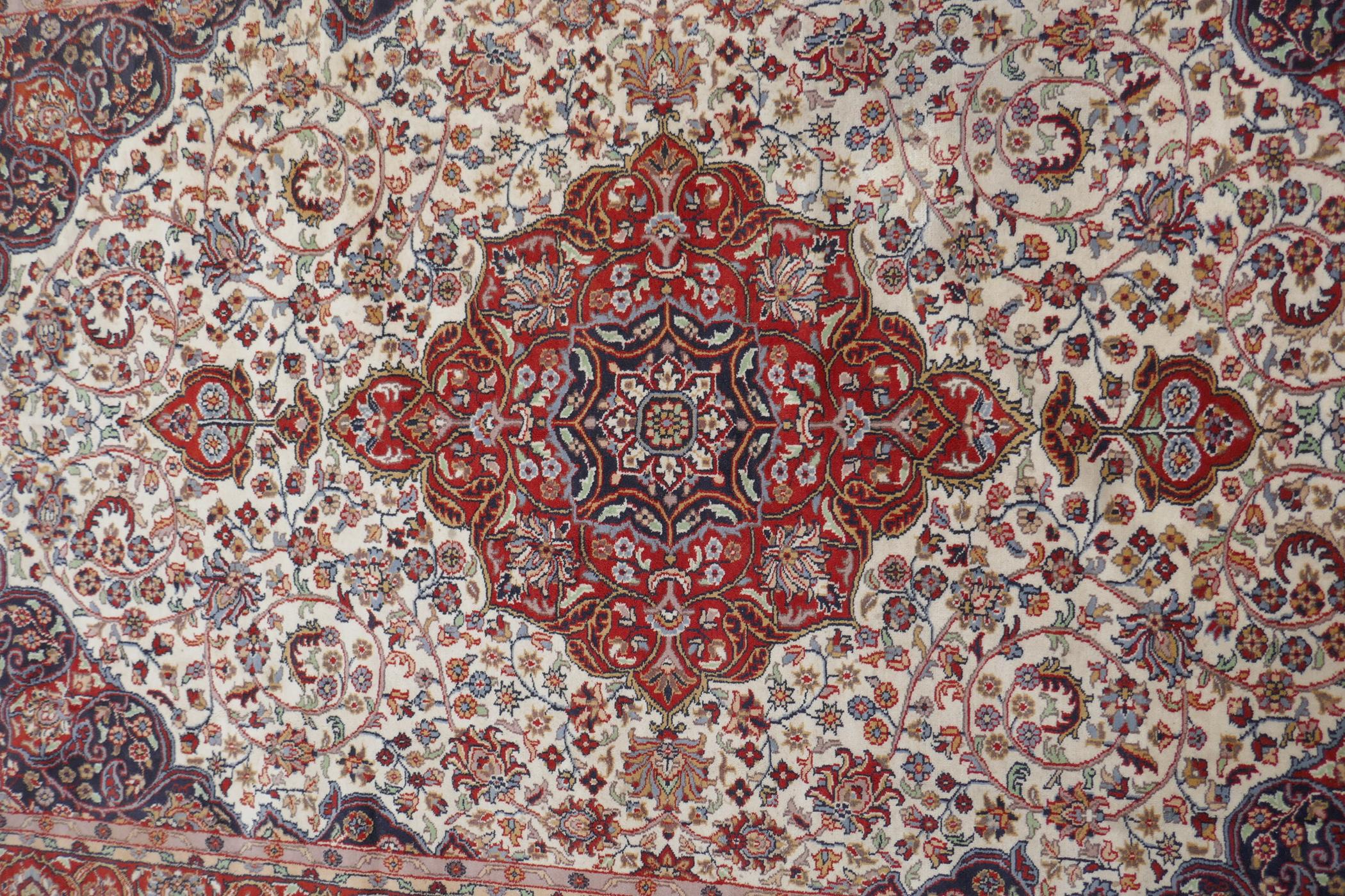 A Persian ivory ground wool Tabriz carpet with a floral medallion and red borders, 180 x 284cm - Image 2 of 6