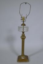 A Victorian brass oil lamp with cut glass reservoir, converted to electricity, 88cm high