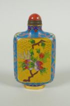 A Chinese cloisonne snuff bottle with decorative panels depicting a peach tree, 9cm high