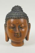 A Chinese filled bronze head bust of Buddha, impressed character mark to base, 19cm high