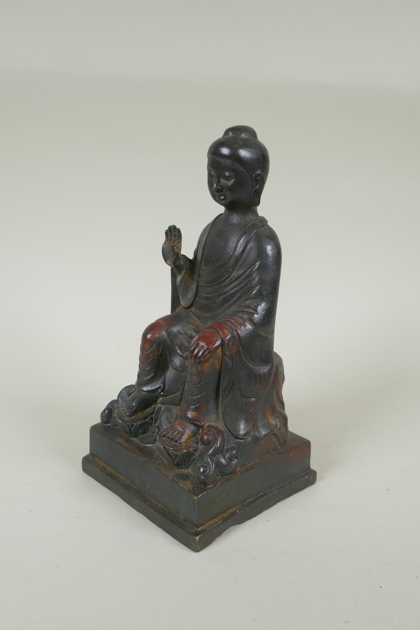 A Chinese bronze Buddha seated on a throne, with the remnants of gilt and copper patina, 23cm high - Image 2 of 5