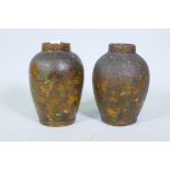 A pair of C19th terracotta jars with decoupage scrapwork decoration, 30cm high