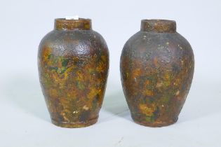 A pair of C19th terracotta jars with decoupage scrapwork decoration, 30cm high