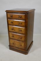 A Victorian figured walnut chest with canted corners and five graduated drawers, raised on a