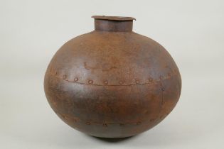 An Indian riveted metal water pot, 30cm high, 35cm diameter