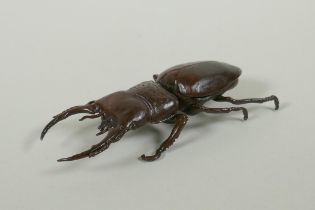 A Japanese style bronze okimono stag beetle, 11cm long