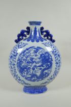 A Chinese blue and white porcelain two handled moon flask, decorated with dragon, phoenix and