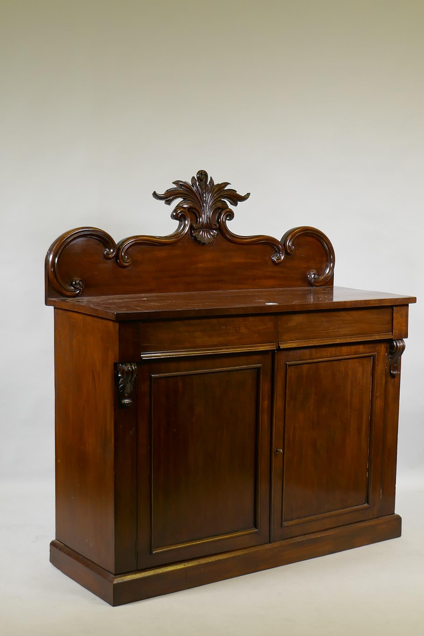 A Victorian mahogany chiffonier, the back with carved crest, the base with two frieze drawers over - Image 3 of 3