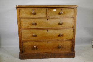 A Victorian faded mahogany chest with two over three drawers, and original wood handles, raised on