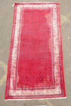 A Persian red ground wool Sarouk Mir rug, 208 x 108cm