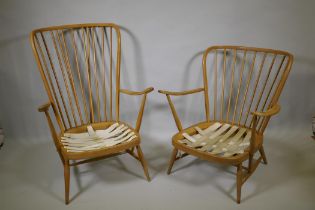 An Ercol beech and elm Windsor tall back armchair Model 478, and a similar Ercol model 334 armchair