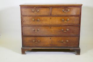 A Georgian oak chest of two over three drawers, mahogany banded top, cockbeaded drawers with