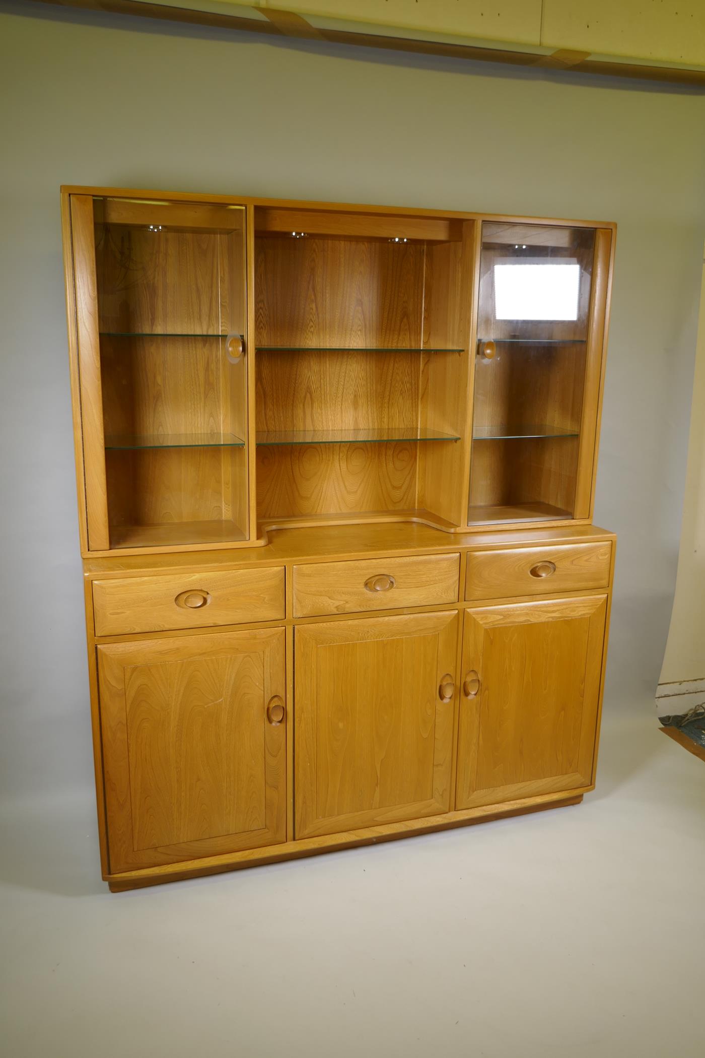 An Ercol elm Windsor high sideboard with two glazed doors to the upper section, and three drawers - Image 2 of 4