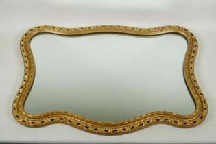 A shaped gilt wall mirror, 68 x 48cm