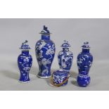 A collection of C19th Chinese blue and white vases with prunus on cracked ice decoration, mismatched
