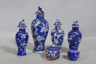A collection of C19th Chinese blue and white vases with prunus on cracked ice decoration, mismatched