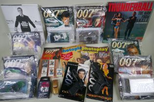 A quantity of James Bond collectors' items to include magazines, reproduction plastic guns, match