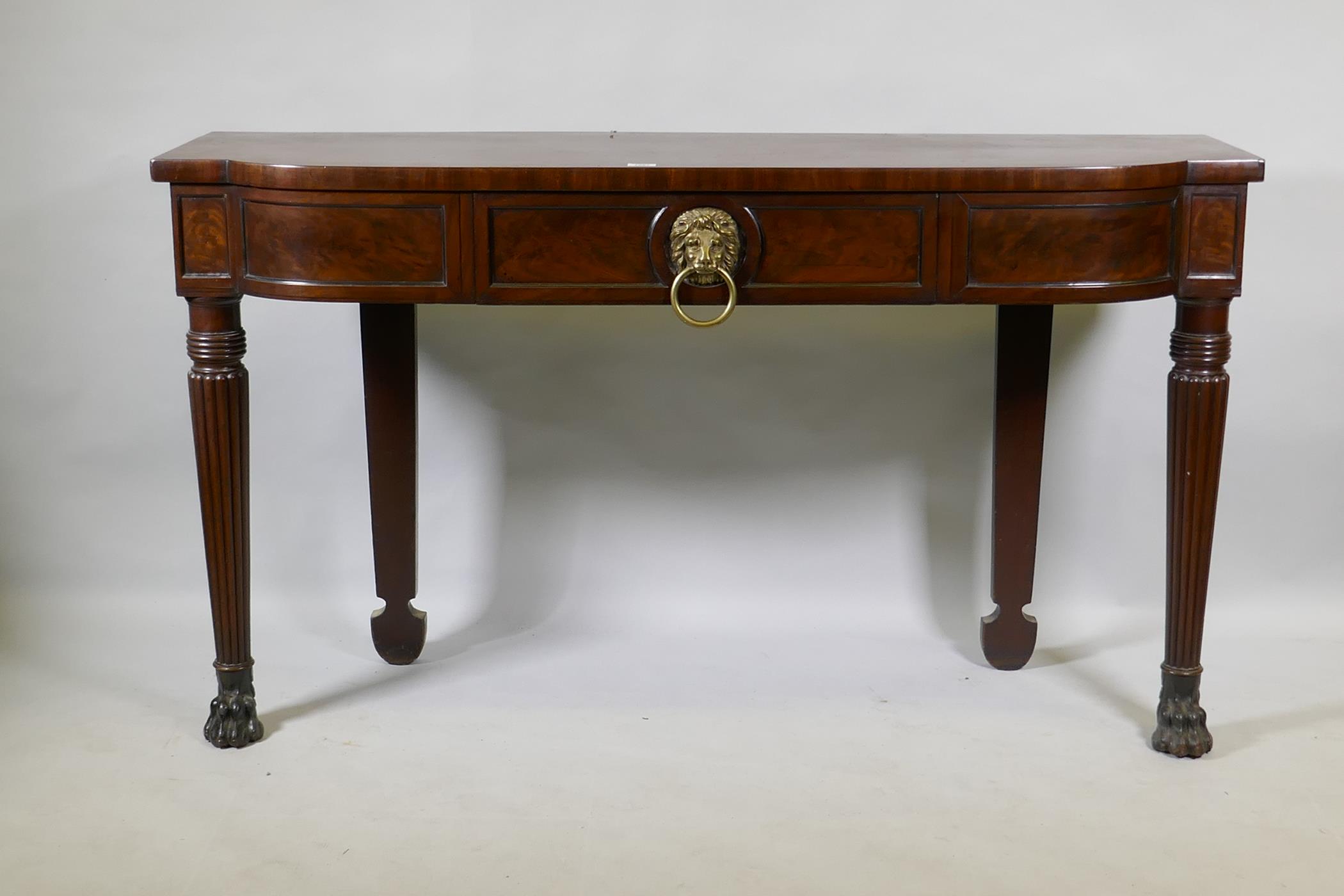 A Georgian mahogany breakfront serving table with panelled frieze and single drawer, raised on