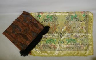 A Chinese machine embroidered gold ground silk throw decorated with boys playing in a garden,