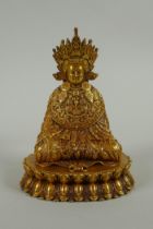 A Sino Tibetan filled gilt bronze Buddha seated on a lotus throne, double vajra mark to base, 11cm