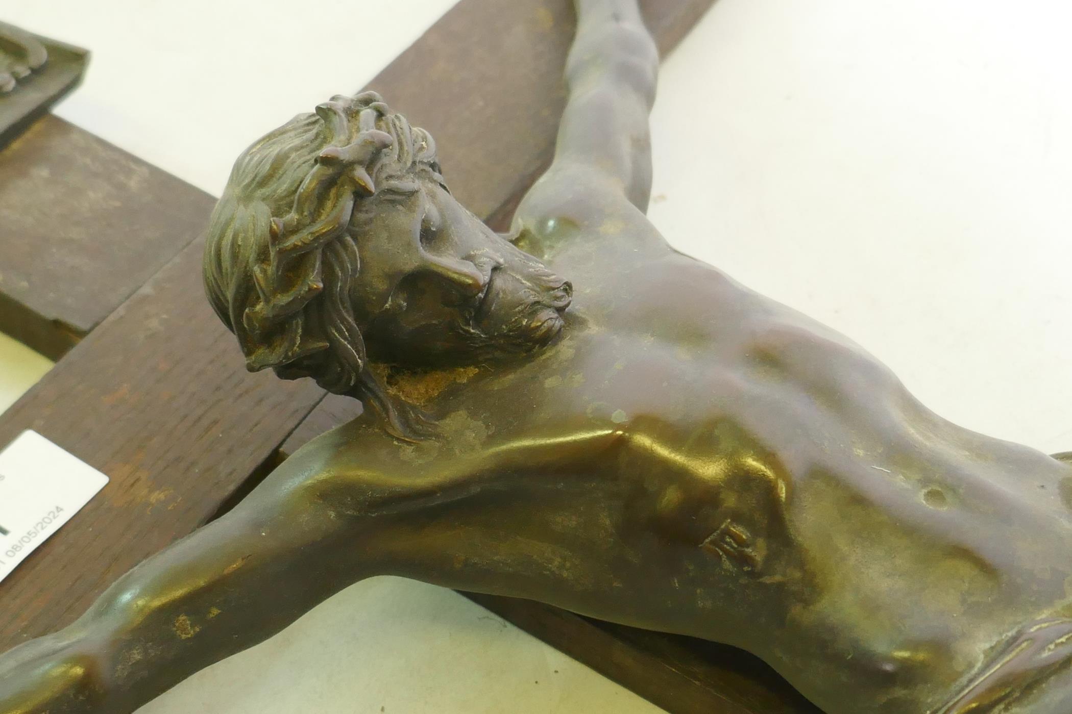 A C19th Continental bronze Corpus Christi, mounted on an oak crucifix with tablet, marked AA, - Image 2 of 6