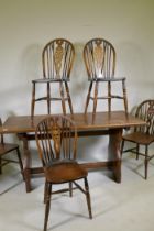 A set of five wheelback kitchen chairs and oak refectory style table, with solid top, early C20th,
