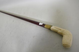 A hardwood walking cane with ivorine handle, 96cm long