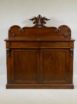 A Victorian mahogany chiffonier, the back with carved crest, the base with two frieze drawers over