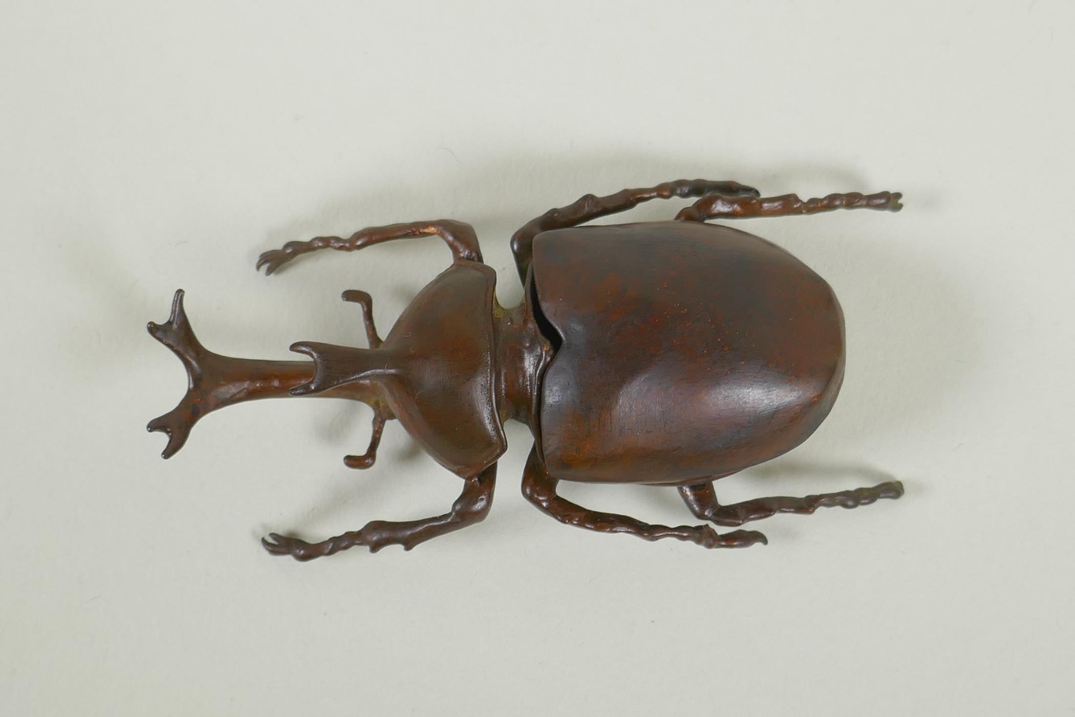 A Japanese style bronze okimono rhinoceros beetle, 9cm long - Image 2 of 3