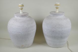 A pair of painted terracotta table lamps, 43cm high